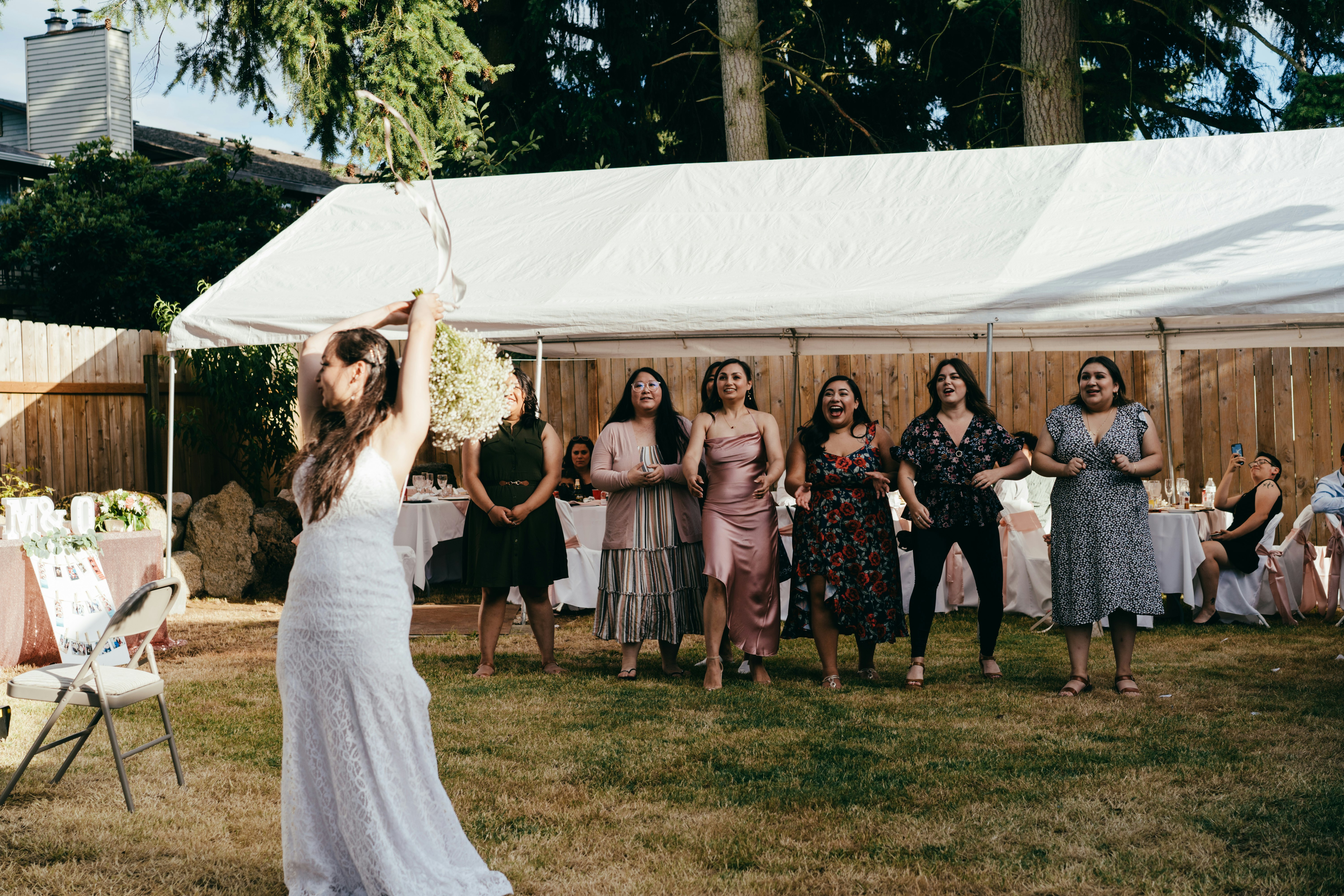 group of people standing on white canopy tent during daytime